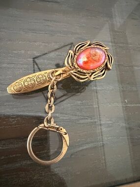 SKOR MOR CORP gold-tone glove clip used to securely hold gloves to a purse.